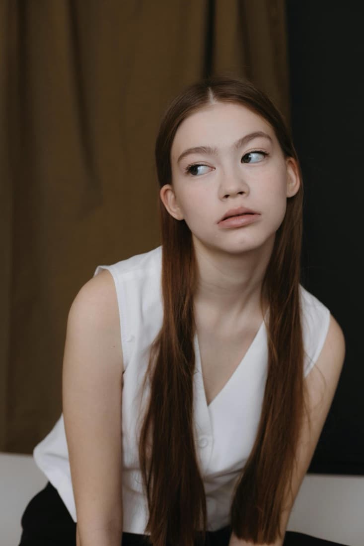 The same young woman appears bare-faced with no glasses or jewelry, before the Accessory Generator adds accessories.