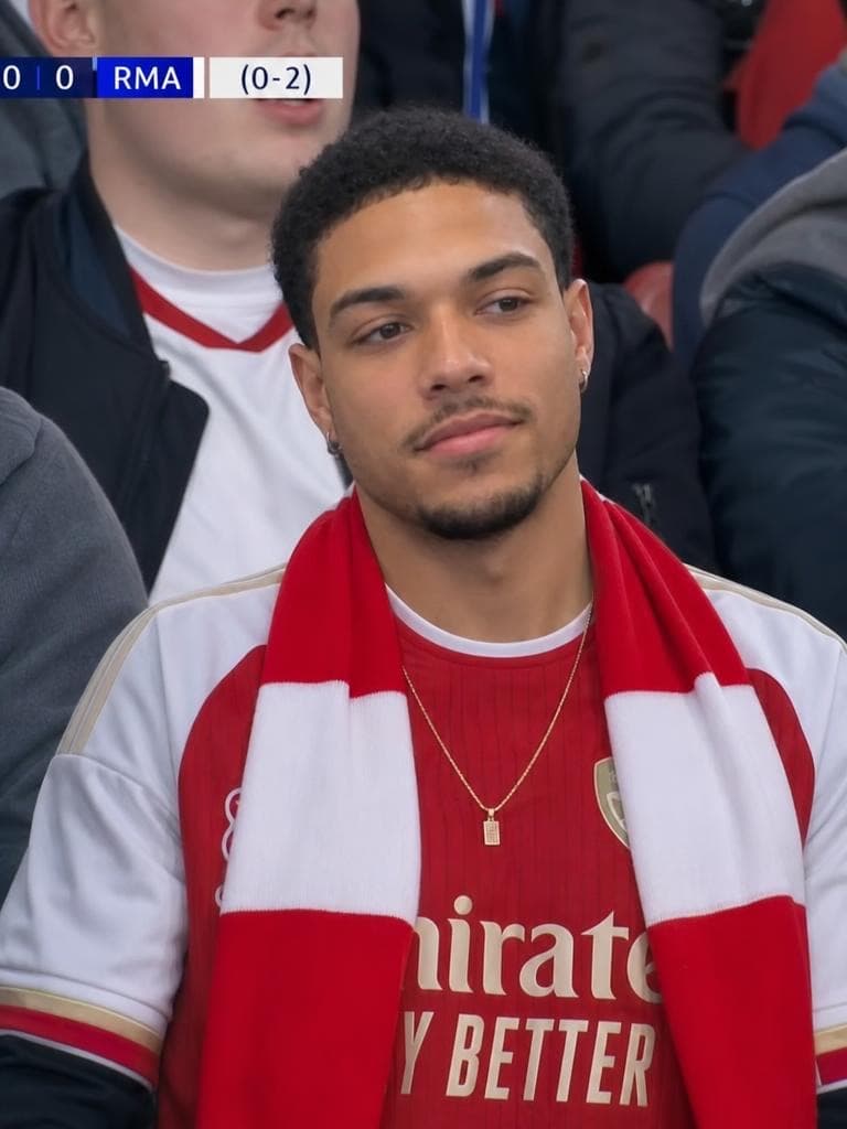 A man in an Arsenal scarf appears at a match with a live scoreboard overlay, created by the Live Broadcast Generator tool.