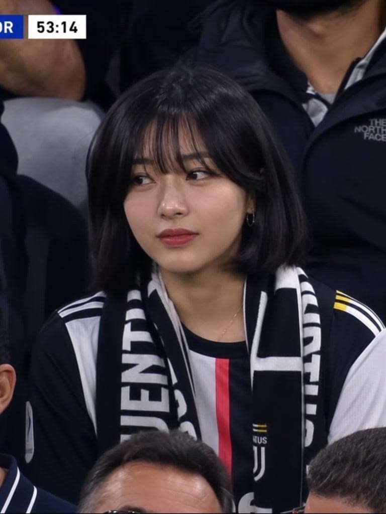 A woman with a black bob sits in a stadium seat wearing a Juventus scarf, with a broadcast clock overlay, styled by the Live Broadcast Generator tool.