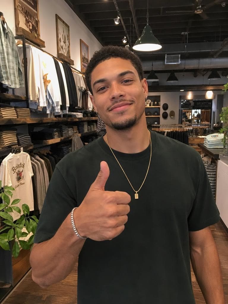 A man gives a thumbs up in a clothing store, before the Live Broadcast Generator places him at a live soccer match.