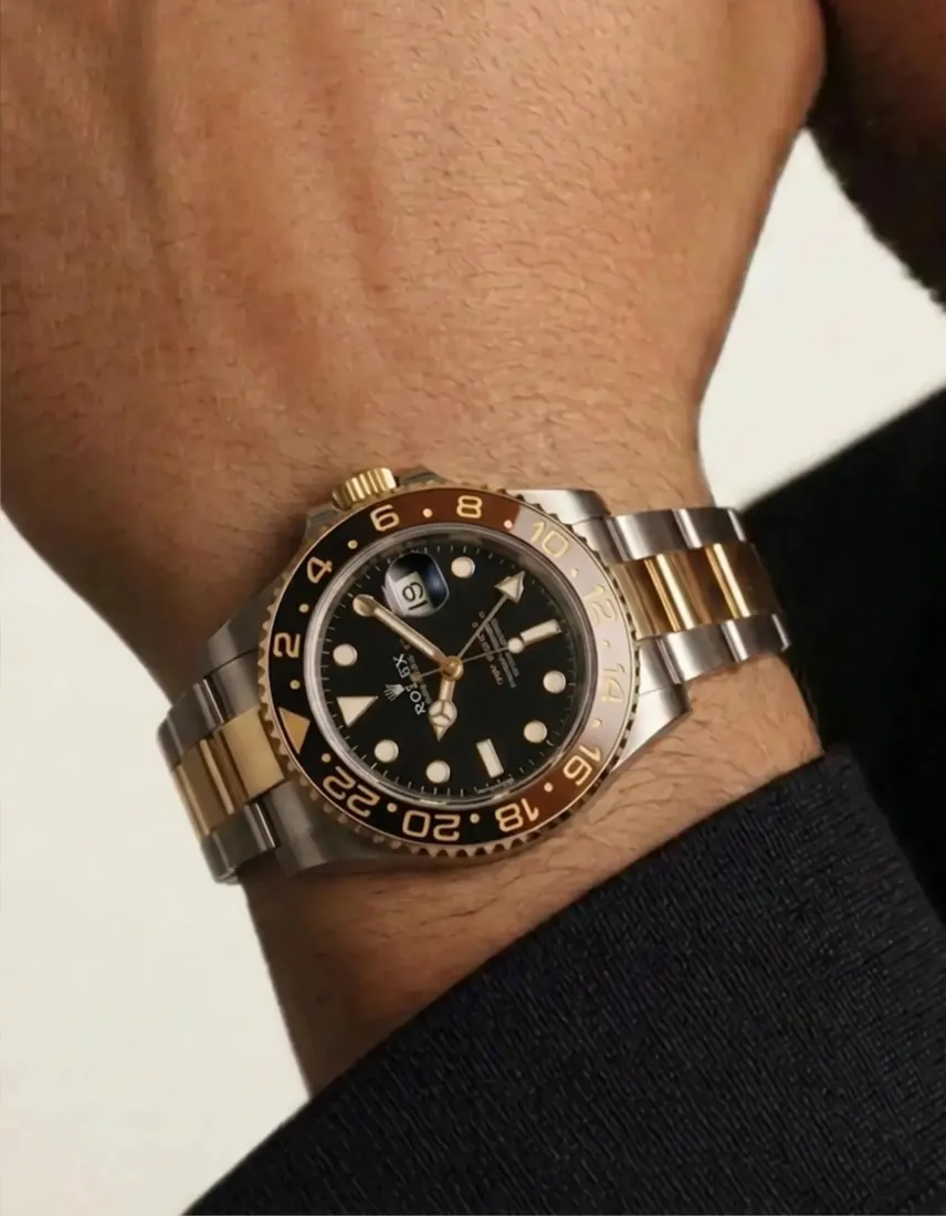 A close-up wrist wears a two-tone gold and steel watch, generated by the Watch Generator tool.